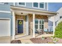 Inviting front porch with brick accents, seating, and blue door with floral wreath at 634 Gants Rd, York, SC 29745
