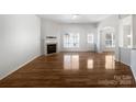 Bright and airy living room features a fireplace, hardwood floors and neutral decor at 7214 Hathaway Ct, Harrisburg, NC 28075