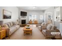Bright and airy living room features a fireplace, hardwood floors and neutral decor at 7214 Hathaway Ct, Harrisburg, NC 28075
