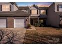 Charming two-story townhouse featuring an attached garage and well-maintained landscaping at 10316 Stineway Ct, Pineville, NC 28134