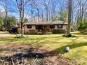 Charming ranch-style home with a well-maintained front yard and mature trees offering shade at 125 Ervin Dr, Gastonia, NC 28056