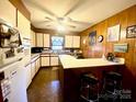 Functional kitchen with modern appliances, white cabinetry, and a breakfast bar area with seating at 125 Ervin Dr, Gastonia, NC 28056