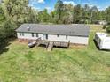 Aerial view of a home featuring a large backyard with wooden deck, boat, and recreational vehicle at 1766 Duckwood Rd, Lancaster, SC 29720