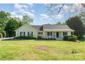 Charming single-story home with a welcoming front porch and well-maintained lawn at 202 Oakwood St, Stanfield, NC 28163