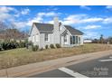 Exterior home view featuring mature landscaping, a brick facade, and easy street access at 203 E 22Nd St, Kannapolis, NC 28083