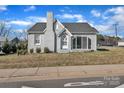 Street-side home view featuring mature landscaping, a brick facade, and easy street access at 203 E 22Nd St, Kannapolis, NC 28083
