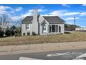View of home featuring mature landscaping, a brick facade, and easy street access at 203 E 22Nd St, Kannapolis, NC 28083