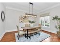 Bright dining room featuring modern lighting, neutral decor, and a large window at 2114 Garden View Ln, Weddington, NC 28104