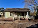 This home offers a quaint covered front porch with white railings and brick accents, welcoming you to a cozy retreat at 2124 W C St, Kannapolis, NC 28081
