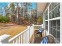 Cozy front porch area with wicker chairs and view of wooded scenery at 2808 Yurman Rd, Charlotte, NC 28214