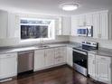 Bright kitchen features stainless steel appliances, granite countertops, and dark wood flooring at 315 Dunham Ave, Salisbury, NC 28146