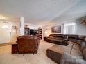 Spacious living room with a leather sectional and recliner, creating a cozy gathering space at 3841 Shasta Cir, Clover, SC 29710