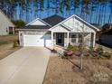 Charming single-Gathering home featuring stone accents, a two-car garage, and a welcoming front porch at 4321 Duplin Dr, Charlotte, NC 28214