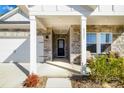 Inviting front porch showcasing stone accents, stylish seating, and the home's address number at 4321 Duplin Dr, Charlotte, NC 28214