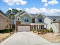 Charming two-story home with manicured lawn, stone accents, and attached two car garage at 4329 Hunton Dale Nw Rd, Concord, NC 28027