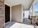 Covered front porch with stone accents and classic columns at 4329 Hunton Dale Nw Rd, Concord, NC 28027