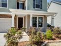 Inviting covered front porch of a home with classic columns and verdant landscaping at 4329 Hunton Dale Nw Rd, Concord, NC 28027