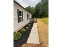 Inviting home exterior with manicured landscaping and a charming walkway at 514 Eagle Mills Rd # 3, Hamptonville, NC 27020