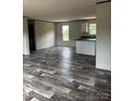 Open-concept living area featuring luxury vinyl plank flooring and neutral paint at 514 Eagle Mills Rd # 3, Hamptonville, NC 27020