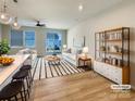 Bright living room with a white sofa, stylish rug, and sliding glass doors to the back yard at 5629 Axil Ln, Charlotte, NC 28269
