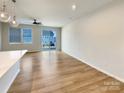 Spacious living room featuring light wood floors and sliding glass doors to the back yard at 5629 Axil Ln, Charlotte, NC 28269