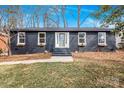 Charming single-story home featuring a dark painted brick facade and a neatly landscaped front yard at 5825 Ruth Dr, Charlotte, NC 28215