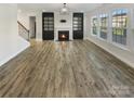 Bright living room featuring hardwood floors and a fireplace at 6234 Artigas Dr, Fort Mill, SC 29707