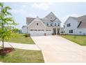 Charming two-story home featuring a three-car garage and covered front porch at 730 Autumn Sage Dr, Indian Trail, NC 28079