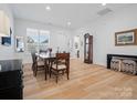 Bright dining room with wood floors, a large window, and a classic dining table at 82116 Standing Oak Dr, Charlotte, NC 28278
