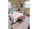 A stylish bedroom with a queen bed, bench, complementary decor, and lots of natural light at 948 Shannon Bradley Rd, Gastonia, NC 28052
