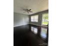 Spacious living room with hardwood floors and a ceiling fan, offering a comfortable space for relaxation and entertaining at 948 Shannon Bradley Rd, Gastonia, NC 28052