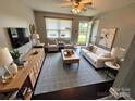A beautifully staged living room with modern furnishings, a large window, and neutral colors at 948 Shannon Bradley Rd, Gastonia, NC 28052