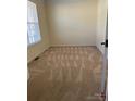 A bright bedroom with neutral carpet and walls, and a window letting in natural light at 1043 Boxelder Ln, Charlotte, NC 28262