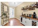 Warm entryway with wood floors, stylish mirror, and convenient bar area at 105 Clarendon St # C, Mooresville, NC 28117