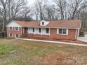 Beautifully designed brick home with a welcoming front porch and expansive lawn at 107 S Myrtle Ave, China Grove, NC 28023