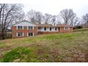 Classic brick residence with a covered front porch nestled on a gently sloping lot at 107 S Myrtle Ave, China Grove, NC 28023