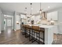 Open-concept kitchen featuring white cabinets, a spacious island with seating, and stainless steel appliances at 1082 Dorsey Dr, Fort Mill, SC 29715