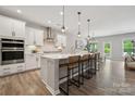 Bright, modern kitchen with a large island, stainless steel appliances, and stylish pendant lighting at 1082 Dorsey Dr, Fort Mill, SC 29715