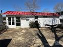 Exterior view of home with bright red roof and boat trailer, with lush greenery at 117 Badin Lake Cir, New London, NC 28127