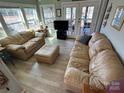 Inviting living room with natural light, comfortable furnishings, and a view of the water at 117 Badin Lake Cir, New London, NC 28127