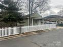 Charming home featuring a classic white picket fence and well-maintained landscaping at 1301 N Mcdowell St, Charlotte, NC 28205