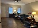 Living room featuring a cozy blue sectional sofa, ceiling fan and neutral wall colors at 1301 N Mcdowell St, Charlotte, NC 28205