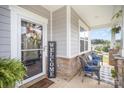 Inviting front porch with comfortable seating and decorative welcome sign, perfect for relaxing outdoors at 205 Falls Cove Dr, Troutman, NC 28166
