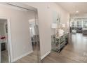 Elegant hallway with mirror accents, decorative table, and stylish decor, leading to the living spaces at 205 Falls Cove Dr, Troutman, NC 28166