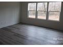 Bright bedroom features modern gray floors and three large windows at 232 Sugar Hill Rd, Troutman, NC 28166