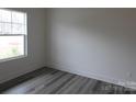 Bright bedroom features modern gray floors and a large window at 232 Sugar Hill Rd, Troutman, NC 28166