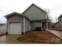 View of the home's exterior featuring the attached garage and neutral siding at 248 Mills Ave, Troutman, NC 28166