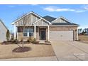 Charming home featuring stone accents, a two-car garage, and well-maintained landscaping at 3012 Seville St, Charlotte, NC 28214