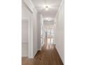 Bright hallway featuring hardwood floors, crown molding, and recessed lighting throughout the home at 3012 Seville St, Charlotte, NC 28214
