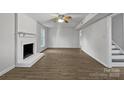 Spacious living room with white painted fireplace, plenty of natural light and hardwood floors at 316 Epperstone Ln, Matthews, NC 28105